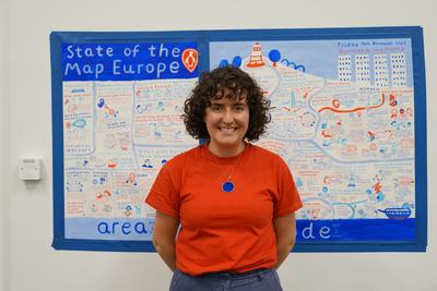 Artist Cara Rooney in front of her SotM Eu 25 artwork