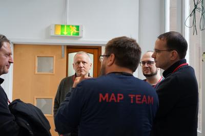 Conversations between delegates and a conference volunteer