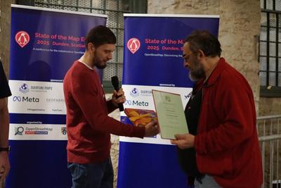 Christian Quest accepts a certificate and prize 